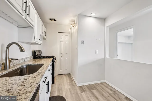 a kitchen with a sink and a refrigerator