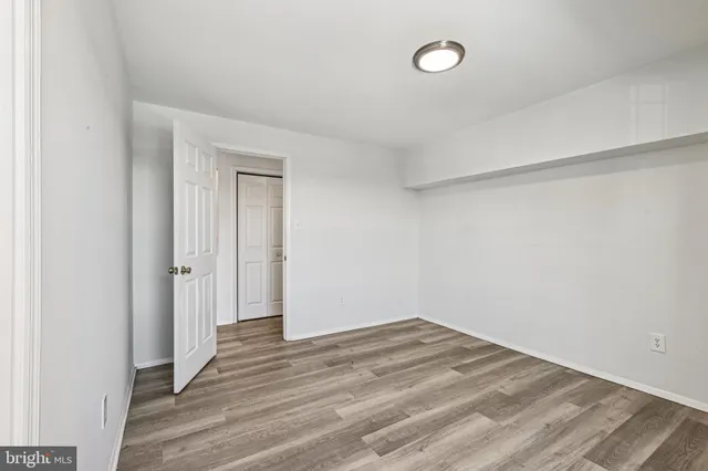 a view of a room with wooden floor and window