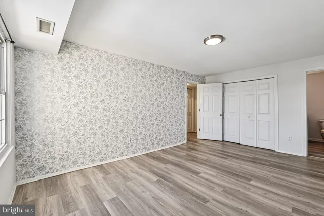 a view of an empty room and wooden floor