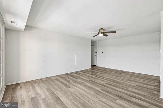 a view of a room with wooden floor