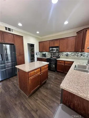 a kitchen with stainless steel appliances granite countertop a stove a sink dishwasher a refrigerator and a oven