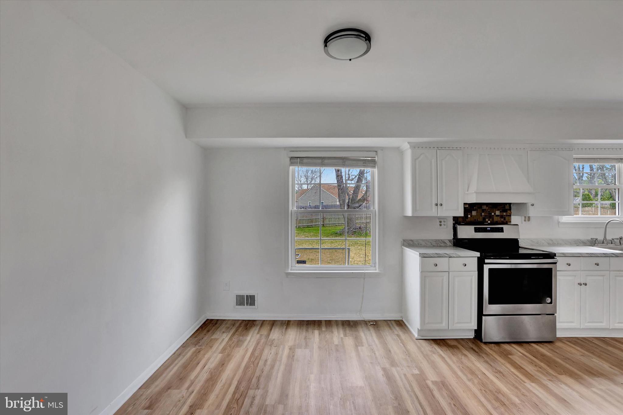 80 Dover Road Westampton, NJ 08060 - Photo 13 of 36 a kitchen with wooden floors and stainless steel appliances