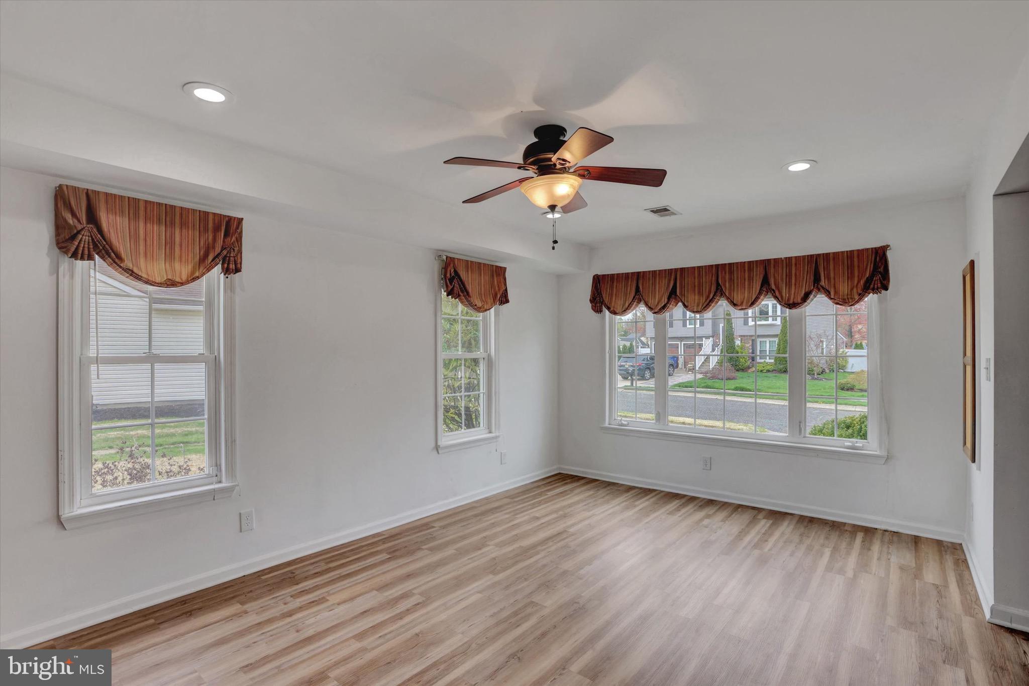80 Dover Road Westampton, NJ 08060 - Photo 18 of 36 a view of an empty room with a window and wooden floor