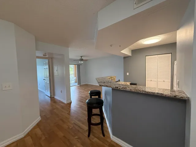a view of a kitchen with kitchen island wooden floor and chair