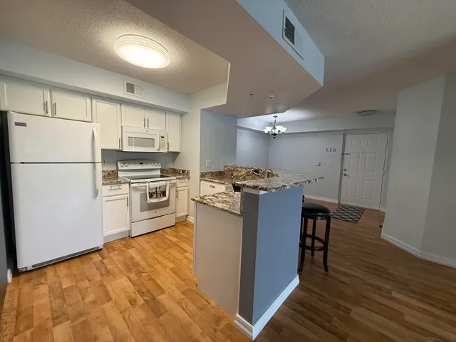 a kitchen with stainless steel appliances a refrigerator and a stove top oven