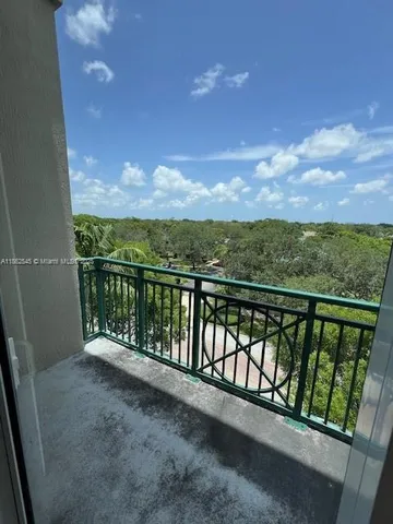 a view of balcony with furniture and city view