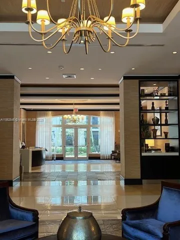 a view of a living room with furniture and chandelier