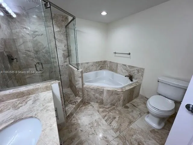 a bathroom with a tub and toilet
