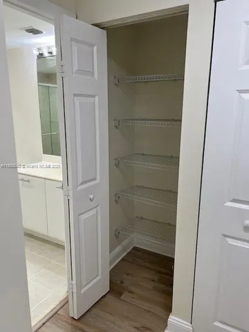 a view of walk in closet with empty racks
