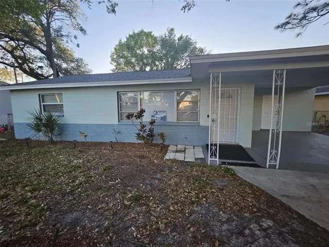 a backyard of a house with table and chairs