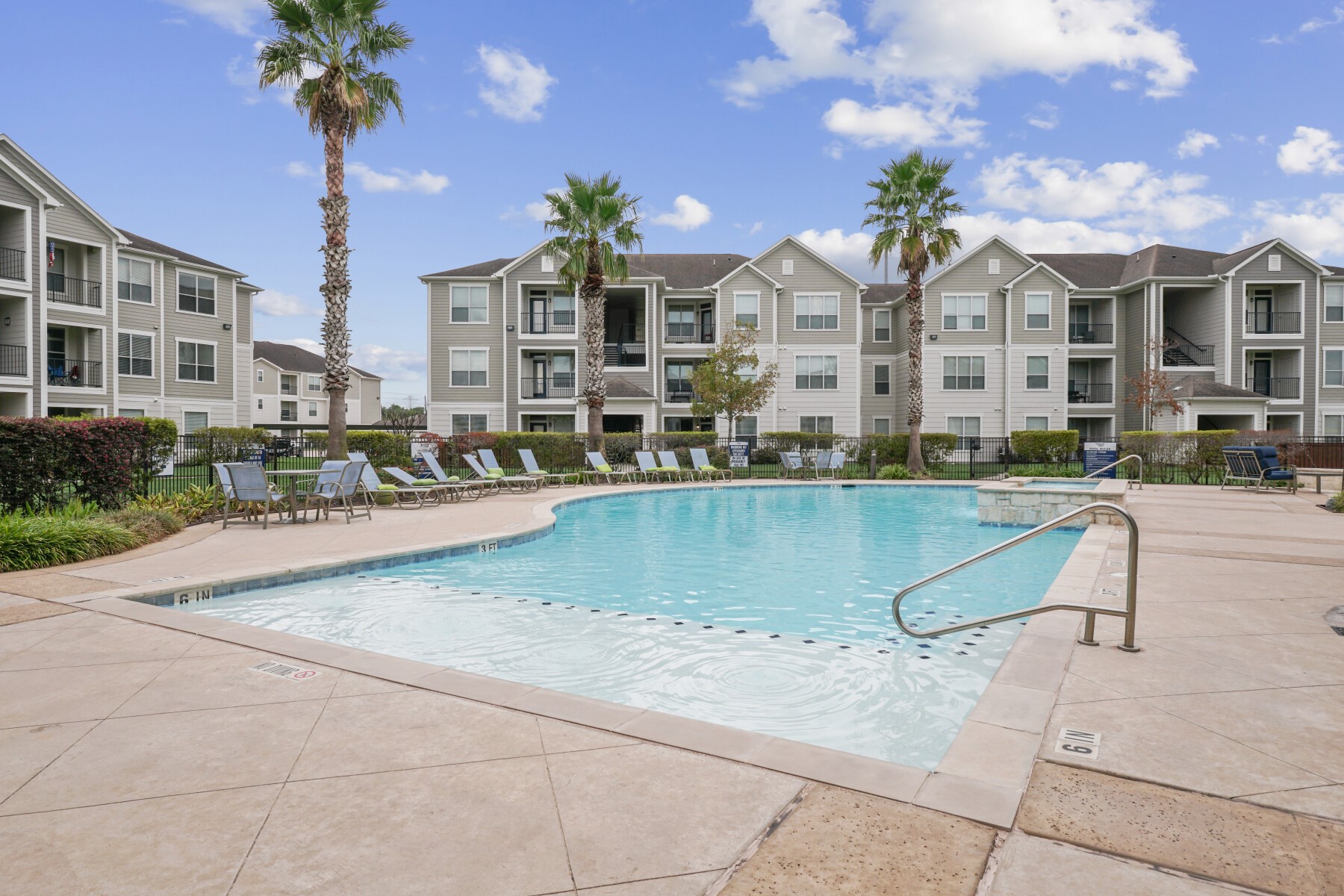 a view of swimming pool with outdoor seating and a garden
