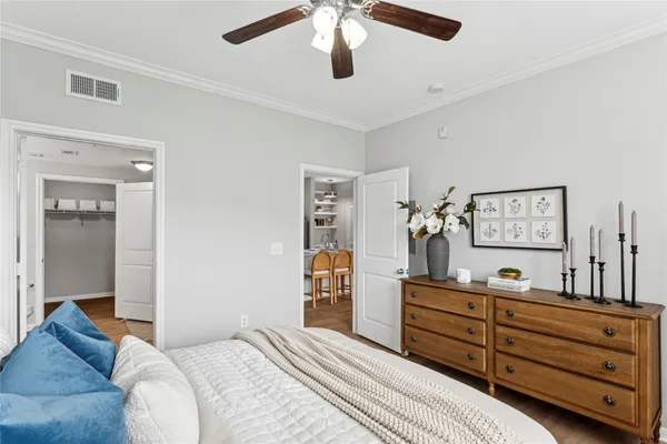 a bedroom with a bed and wooden floor