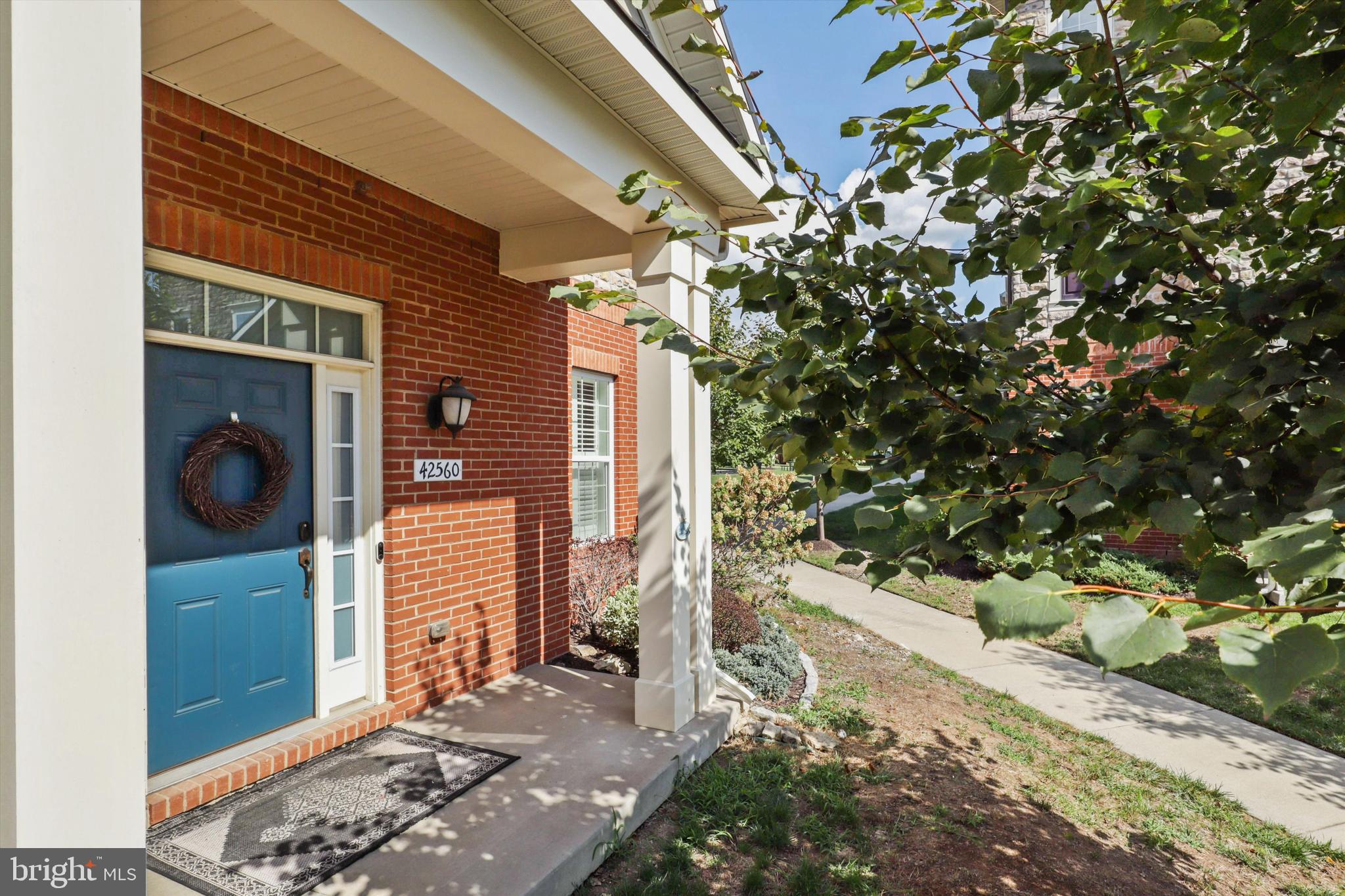 42560 Sunset Ridge Square Ashburn, VA 20148 - Photo 1 of 29 a pathway of a house with a yard