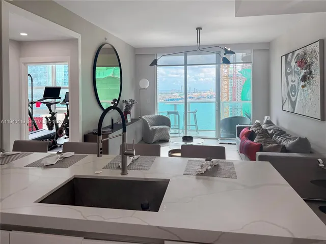 a living room with large mirror and a large window