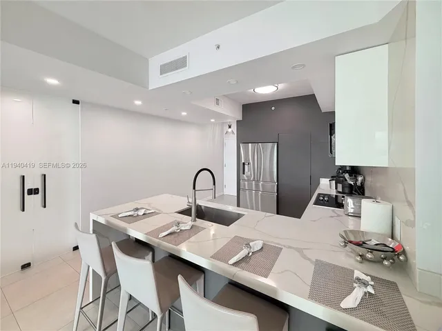 a kitchen with a dining table cabinets and sink