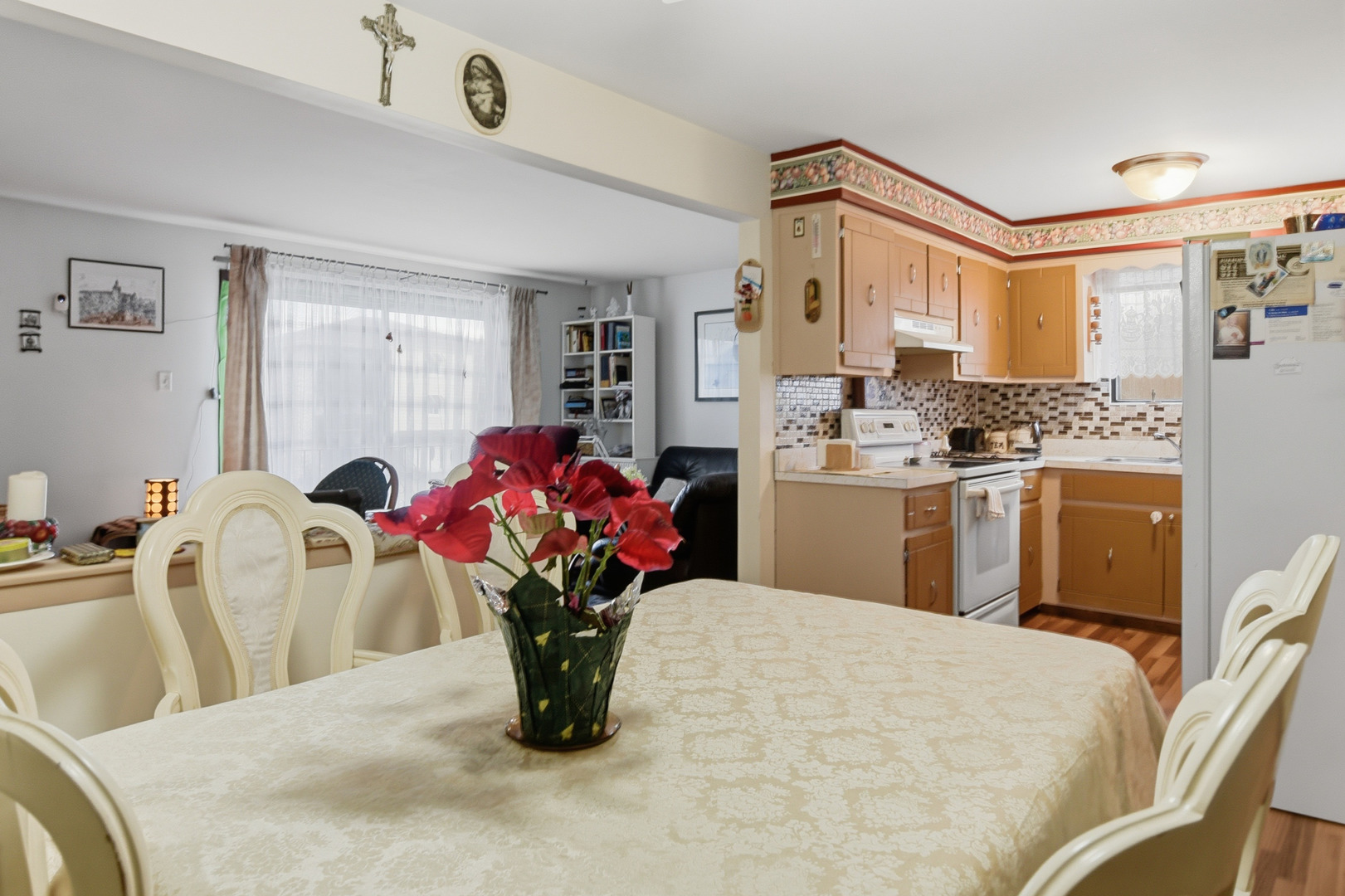 7329 West 85th Place, Unit 2A Bridgeview, IL 60455 - Photo 10 of 15 a kitchen with stainless steel appliances kitchen island granite countertop a stove a sink dishwasher and white cabinets with wooden floor