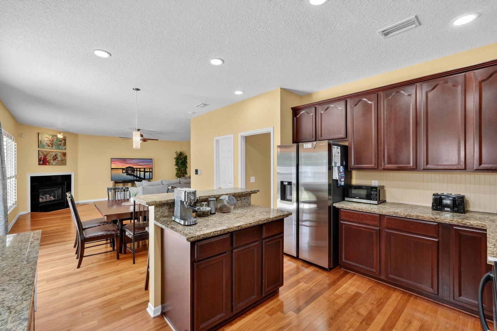 1237 Splendid Ravine Street St. Augustine, FL 32092 - Photo 15 of 62 a kitchen with stainless steel appliances granite countertop wooden cabinets a stove top oven a sink and dishwasher