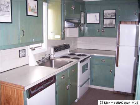 312 Morris Avenue, Unit UPPR Spring Lake, NJ 07762 - Photo 2 of 3 a kitchen with a sink cabinets and a refrigerator