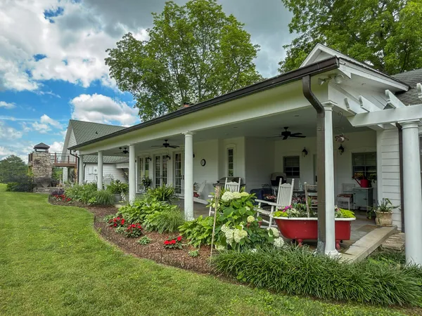 a view of a house with porch and garden