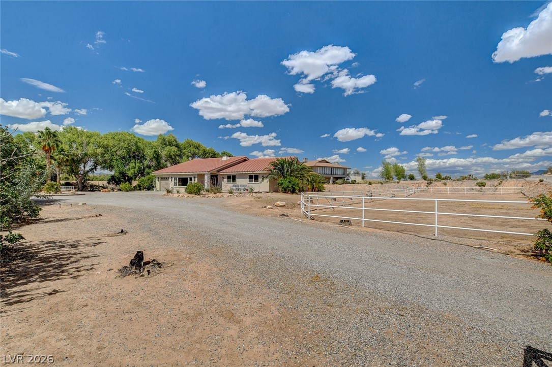 1950 Bowman Road Logandale, NV 89021 - Photo 26 of 98 Gravel driveway leads to a desert oasis with a charming house and ample space.