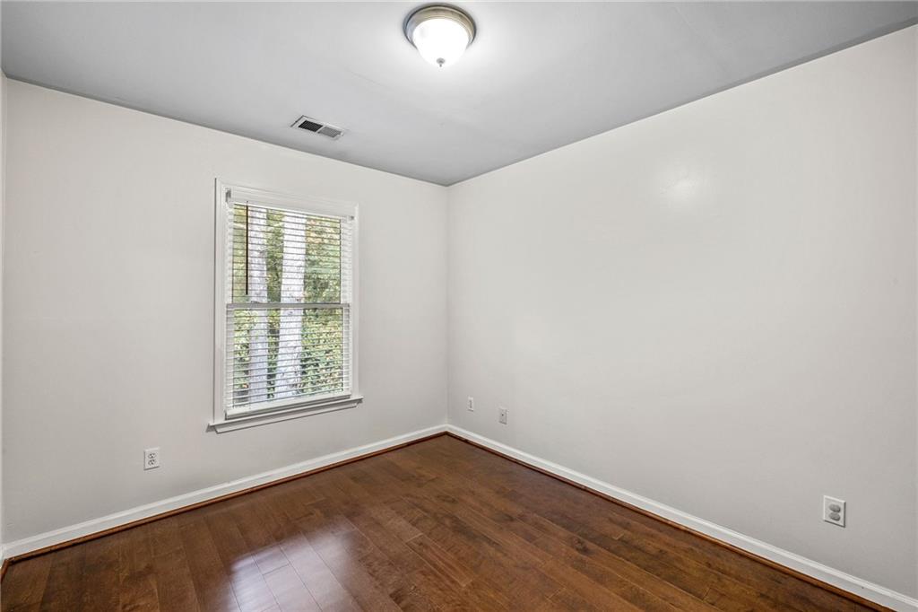 5323 Sherwin Drive Norcross, GA 30093 - Photo 15 of 20 an empty room with wooden floor and windows