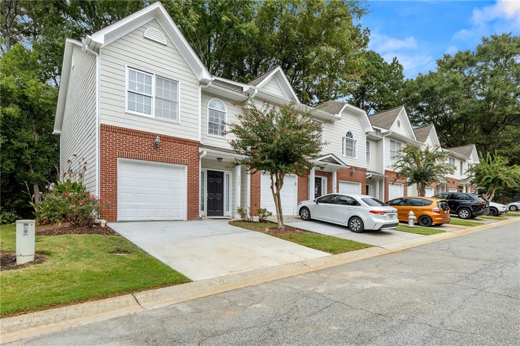 5323 Sherwin Drive Norcross, GA 30093 - Photo 20 of 20 a front view of a house with a garden and parking