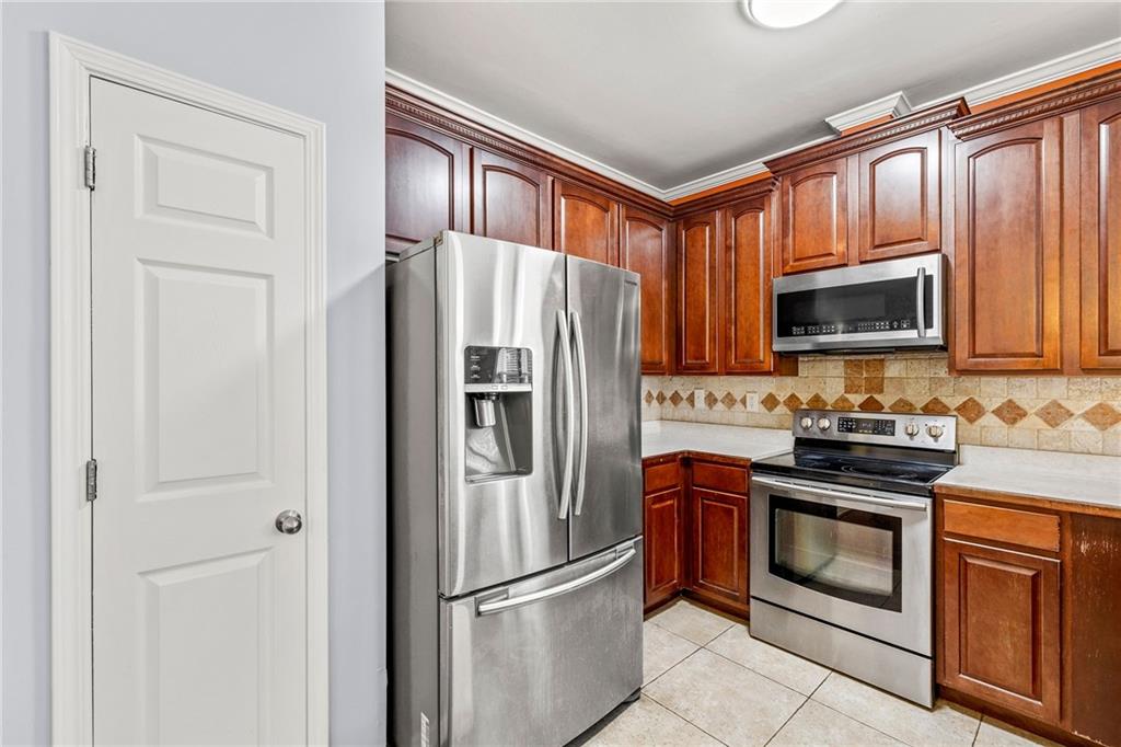 5323 Sherwin Drive Norcross, GA 30093 - Photo 4 of 20 a kitchen with granite countertop stainless steel appliances a refrigerator stove and microwave