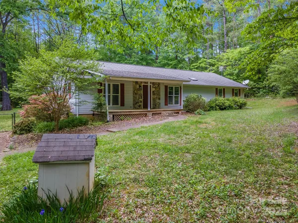 a view of a house with a yard and sitting area