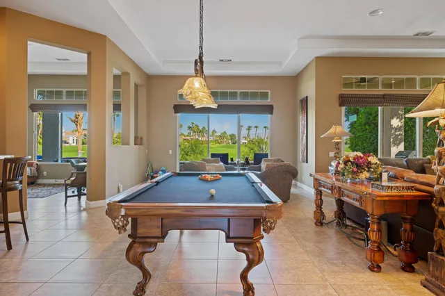 a living room with fireplace furniture and a potted plant