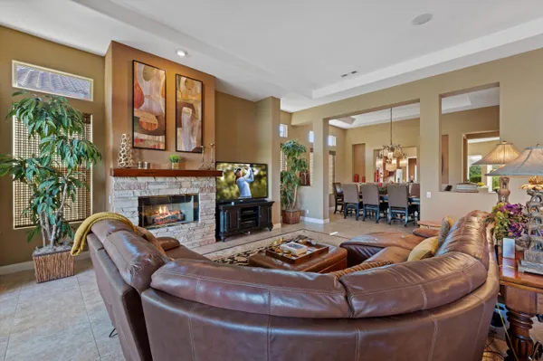 a living room with furniture and a chandelier