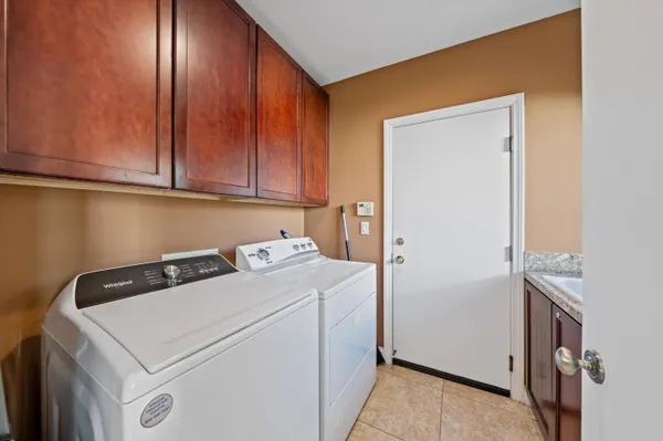 a spacious bedroom with a bed a window and dresser