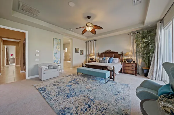 a bedroom with a bed dresser and window