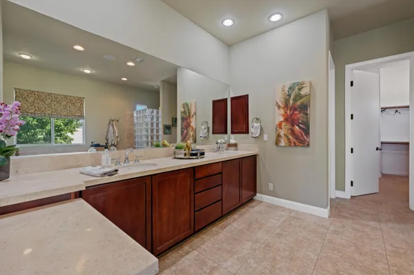 a spacious bedroom with a bed and a chandelier