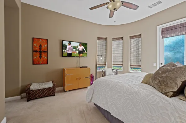 a bedroom with a bed and a chandelier