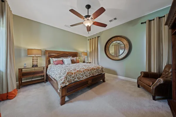 a front view of a house with a garden and plants