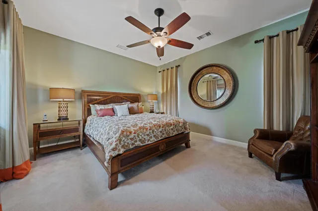 a front view of a house with a garden and plants