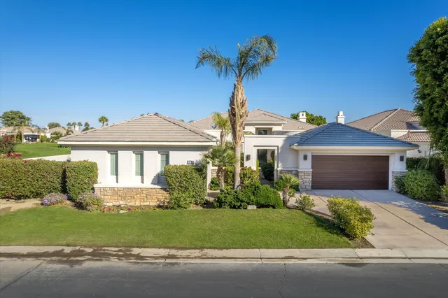 a view of a house with sitting area and swimming pool