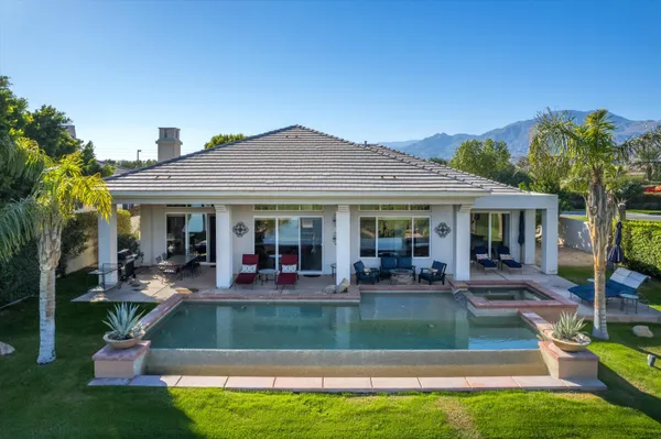 a view of a patio with a table chairs and a backyard