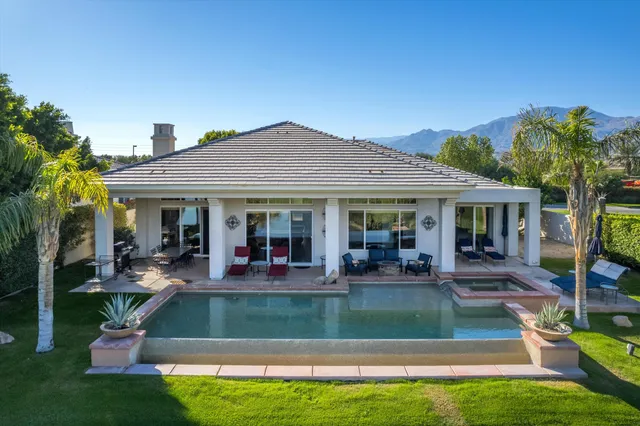 a view of a patio with a table chairs and a backyard