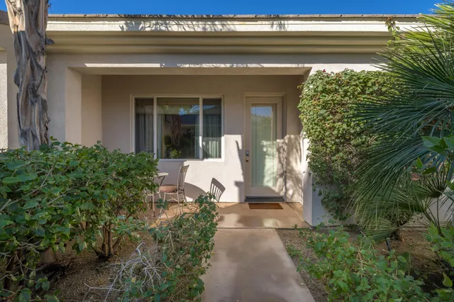 a balcony with furniture and a potted plant