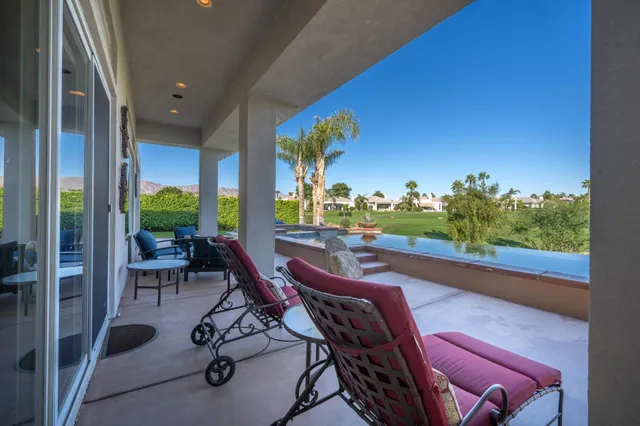 a view of a house with a yard patio and swimming pool