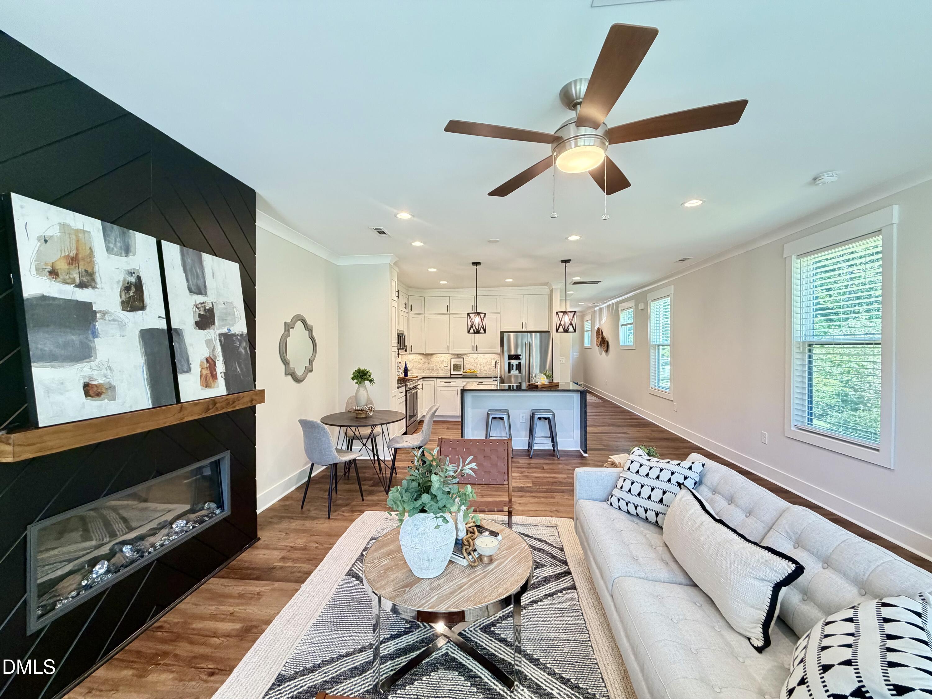 4016 Emerald Green Road Raleigh, NC 27612 - Photo 6 of 22 a living room with furniture a fireplace and a window
