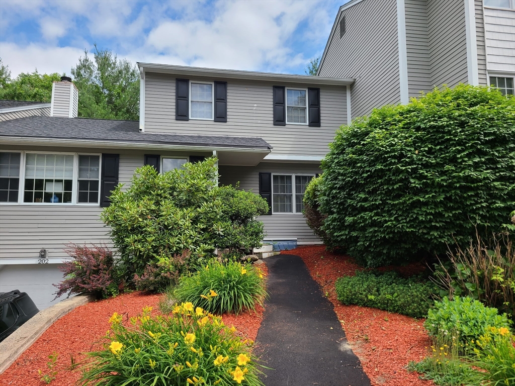 202 Torrey Ln Extension, Unit 202 Holden, MA 01520 - Photo 1 of 32 a view of a house with potted plants and large tree