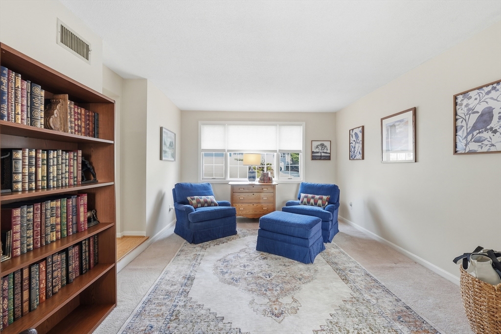 202 Torrey Ln Extension, Unit 202 Holden, MA 01520 - Photo 16 of 32 a living room with furniture and a book shelf