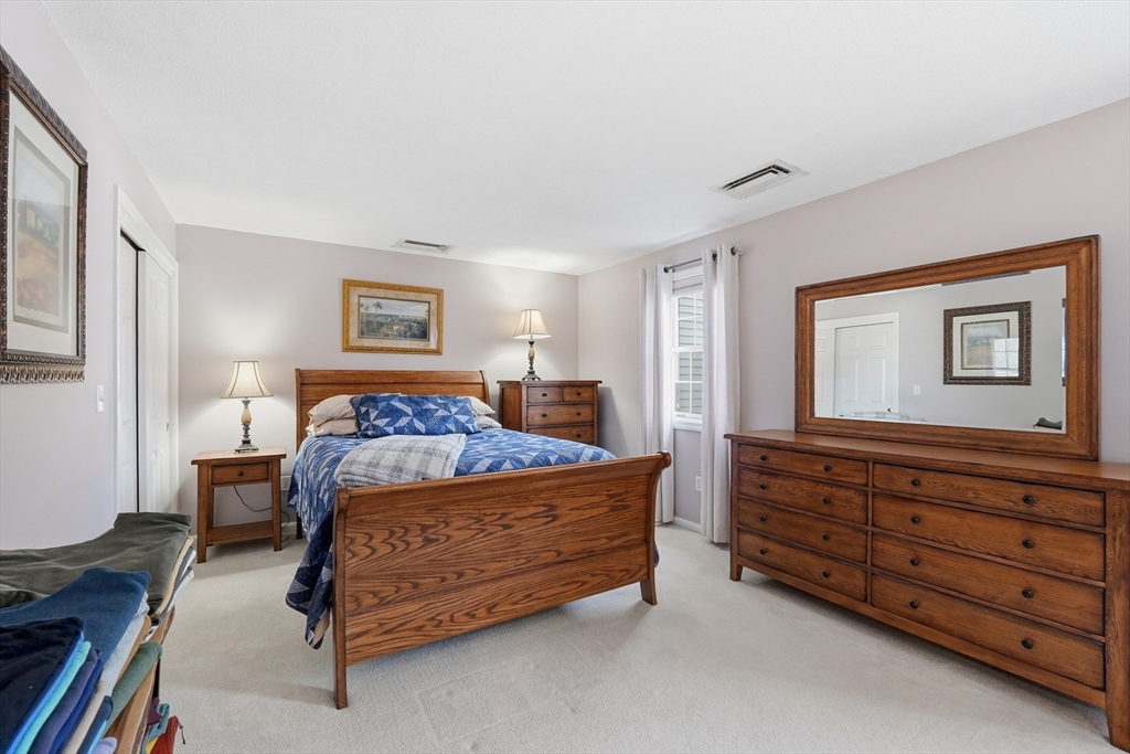 202 Torrey Ln Extension, Unit 202 Holden, MA 01520 - Photo 18 of 32 a bedroom with a bed and a dresser