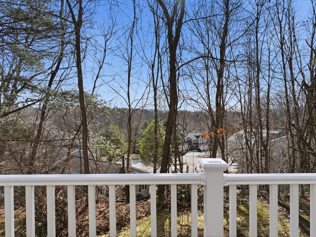 202 Torrey Ln Extension, Unit 202 Holden, MA 01520 - Photo 27 of 32 a view of a wooden fence and trees
