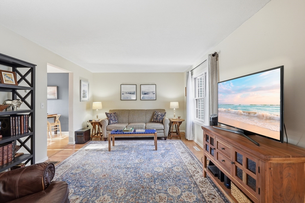 202 Torrey Ln Extension, Unit 202 Holden, MA 01520 - Photo 6 of 32 a living room with furniture and a flat screen tv
