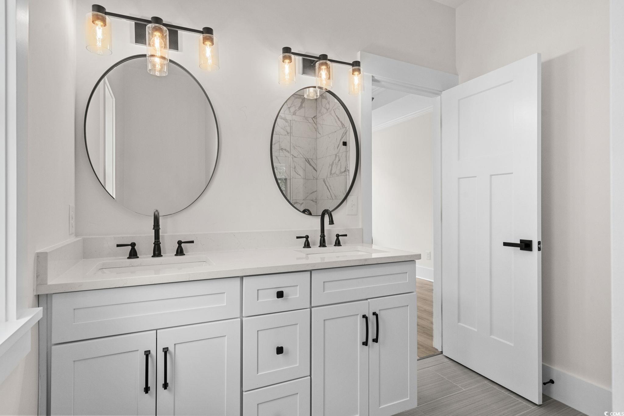 382 Waties Drive Murrells Inlet, SC 29576 - Photo 28 of 40 Bathroom with double vanity and wood finished floo