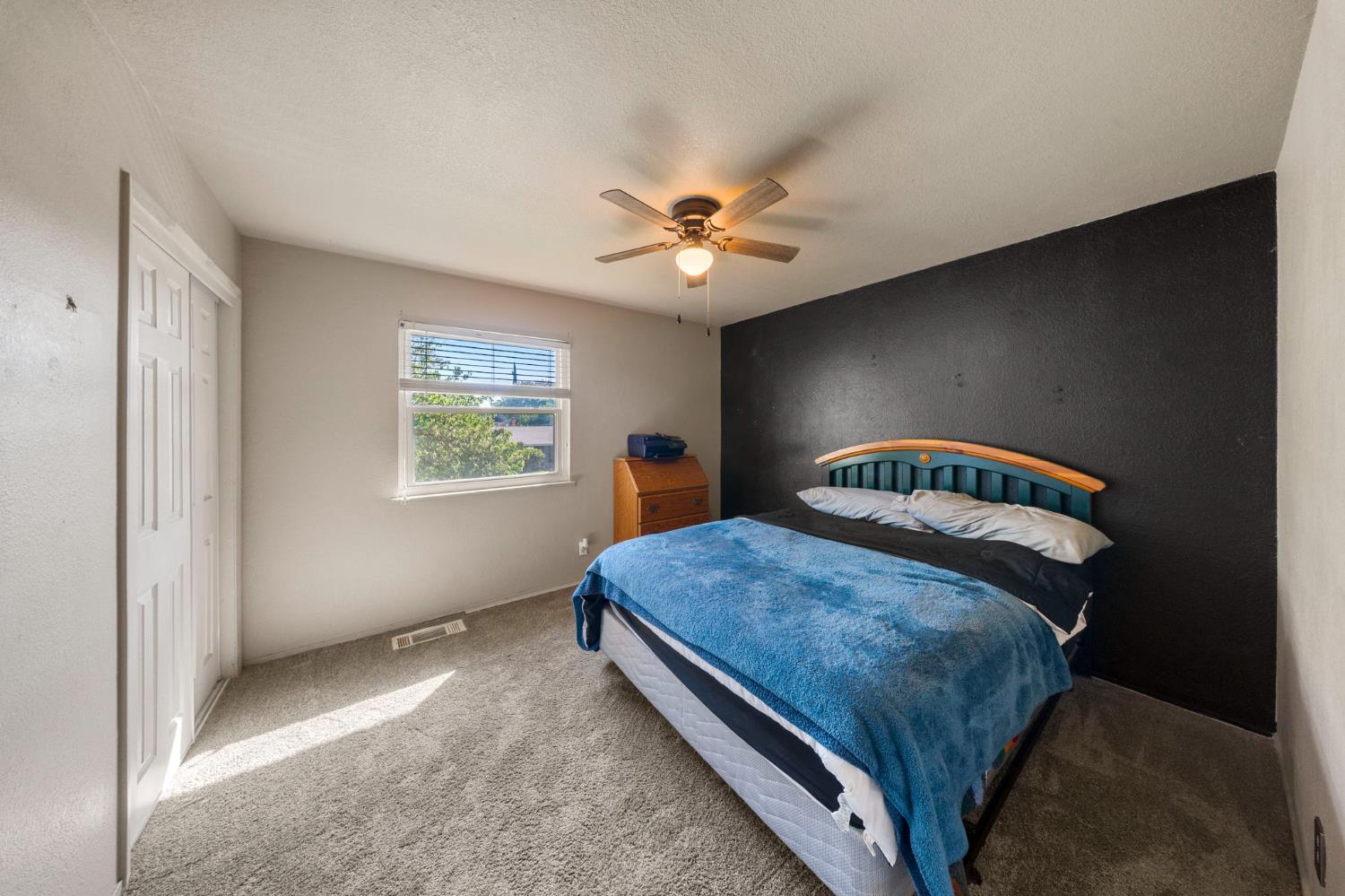 2779 Story Avenue Merced, CA 95340 - Photo 11 of 27 a bedroom with a bed and a window