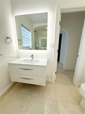 a bedroom with two beds and a large window